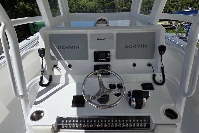 Slide: The Image of 2020 Invincible 35 Catamaran helm with Garmin displays and Mercury controls. - 24
