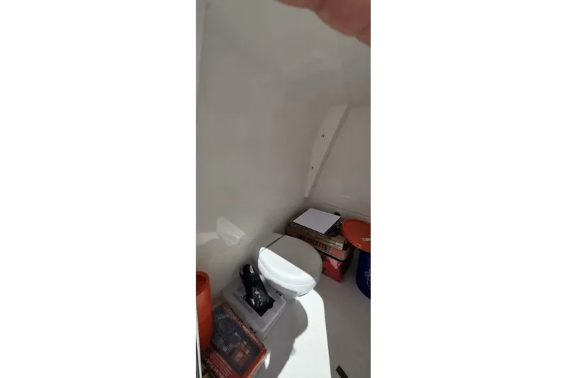 Slide: The Image of Interior of 2020 Invincible 35 Catamaran showing storage area with toilet and supplies. - 25