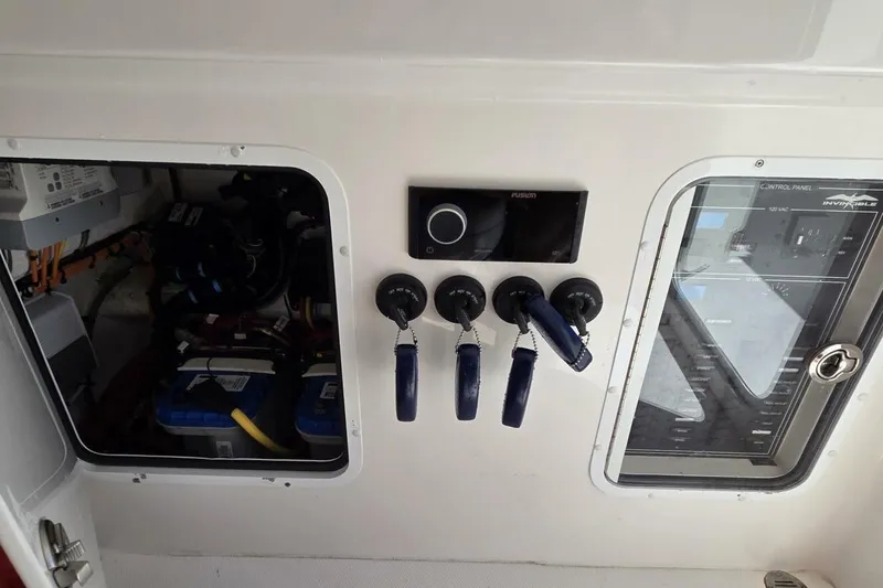 Slide: The Image of Control panel of 2020 Invincible 35 Catamaran with switches and wiring. - 27