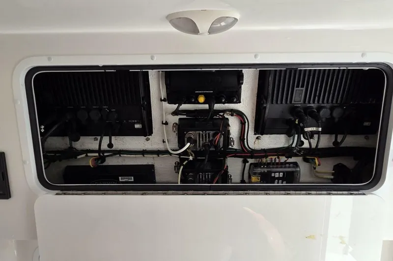 Slide: The Image of Electrical panel inside 2020 Invincible 35 Catamaran, showcasing wiring and components. - 28