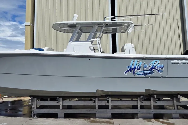 Slide: The Image of 2020 Invincible 35 Catamaran on dock, featuring "Hit'n Run" graphic. - 43
