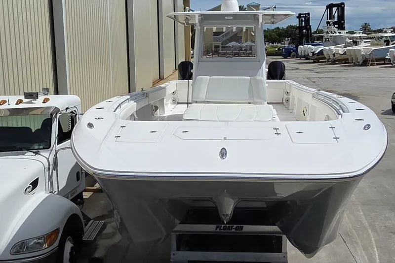 Slide: The Image of 2020 Invincible 35 Catamaran on trailer, parked beside a truck in a marina. - 48