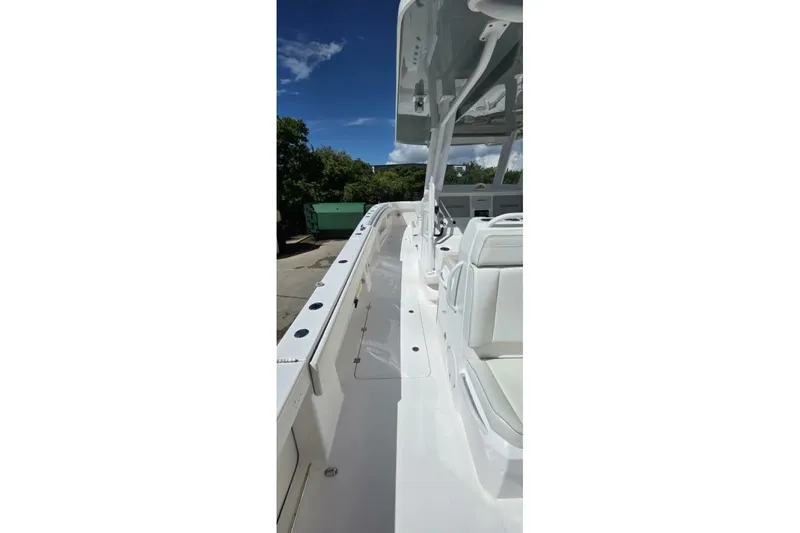 Slide: The Image of 2020 Invincible 35 Catamaran with sleek white deck and seating under clear blue sky. - 5