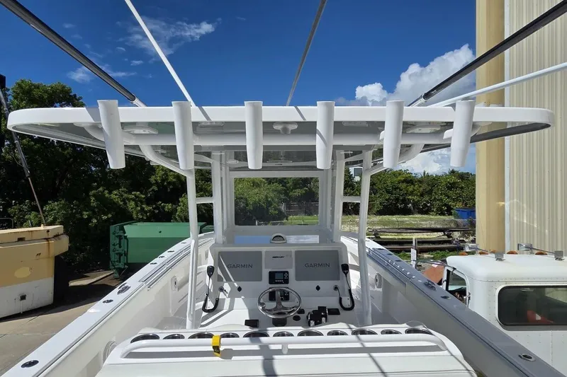 Slide: The Image of 2020 Invincible 35 Catamaran cockpit with Garmin navigation, docked outdoors. - 7