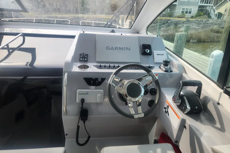 Slide: The Image of Helm of 2025 Beneteau Gran Turismo 32 with Garmin navigation system and controls. - 15