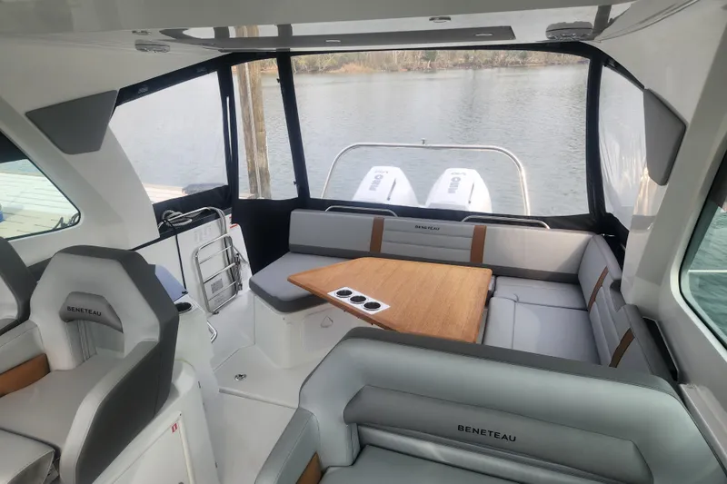 Slide: The Image of Interior of 2025 Beneteau Gran Turismo 32 yacht with seating and table, overlooking water. - 16