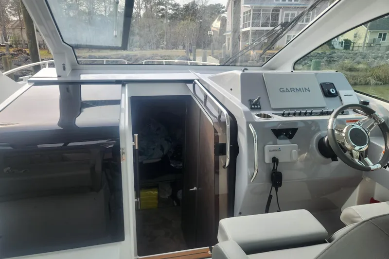 Slide: The Image of Interior cockpit view of 2025 Beneteau Gran Turismo 32 with Garmin navigation system. - 17
