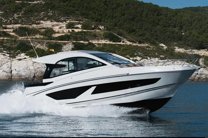Slide: The Image of Manufacturer Provided Image: Beneteau Gran Turismo 32 2025 cruising on water near rocky coastline. - 20