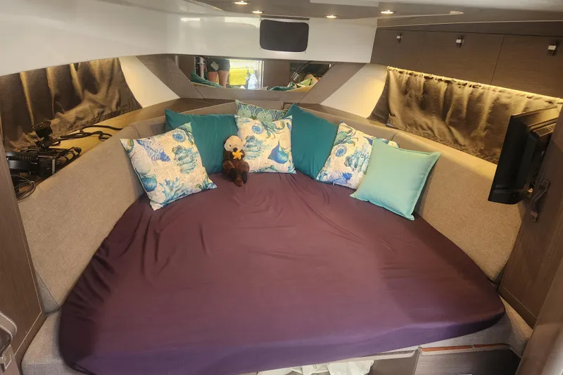 Slide: The Image of Luxurious interior of 2025 Beneteau Gran Turismo 32 with plush bedding and decorative pillows. - 26