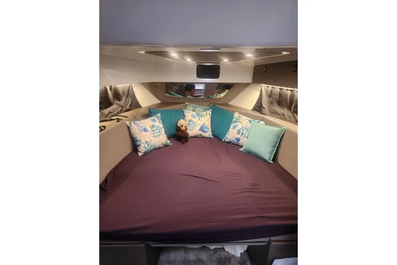 Slide: The Image of Interior cabin of 2025 Beneteau Gran Turismo 32 with plush bedding and decorative pillows. - 33