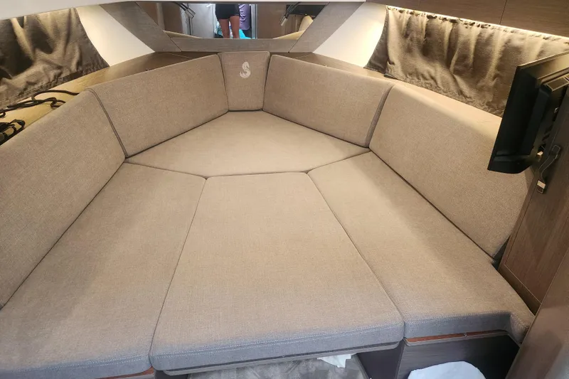 Slide: The Image of 2025 Beneteau Gran Turismo 32 interior cabin with beige seating and modern design. - 35