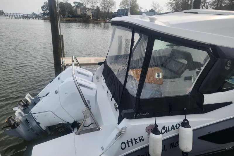 Slide: The Image of 2025 Beneteau Gran Turismo 32 docked, featuring sleek design and powerful outboard engines. - 4