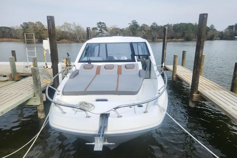 Slide: The Image of 2025 Beneteau Gran Turismo 32 docked, showcasing sleek design and spacious deck. - 5