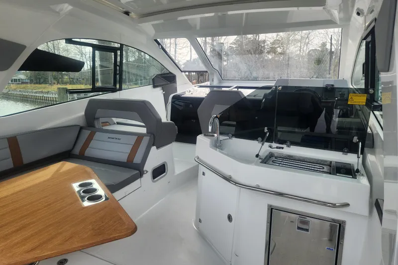 Slide: The Image of Interior of 2025 Beneteau Gran Turismo 32 yacht with seating and kitchenette. - 9
