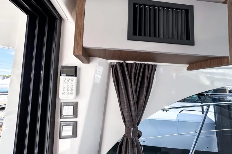 Slide: The Image of Interior view of 2023 Beneteau Antares 11 with control panel and curtain. - 17
