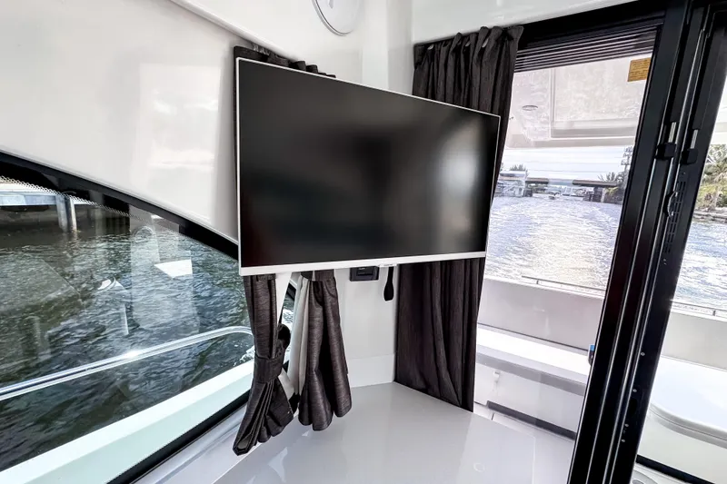 Slide: The Image of Interior of 2023 Beneteau Antares 11 with mounted TV and water view. - 20