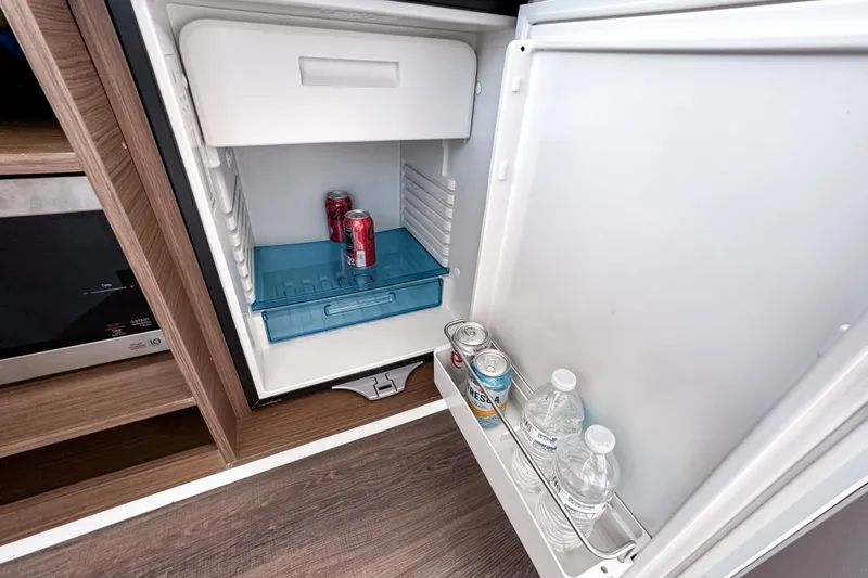 Slide: The Image of Mini fridge in 2023 Beneteau Antares 11 yacht, stocked with drinks. - 22