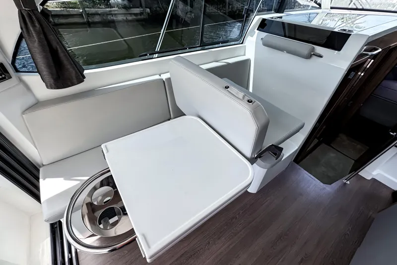 Slide: The Image of Interior of 2023 Beneteau Antares 11, featuring a modern seating area and table. - 23