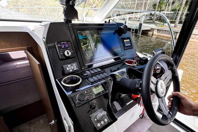 Slide: The Image of 2023 Beneteau Antares 11 helm with advanced navigation and control systems. - 26