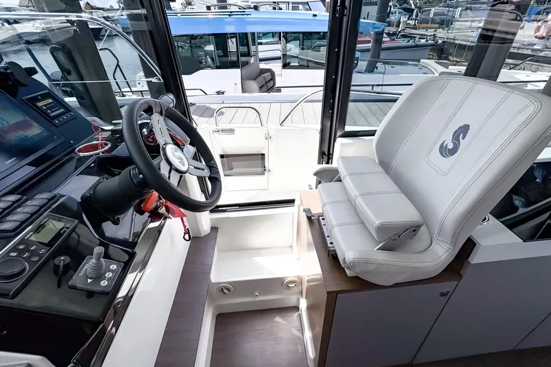 Slide: The Image of Interior cockpit of 2023 Beneteau Antares 11, featuring steering wheel and captain's chair. - 28