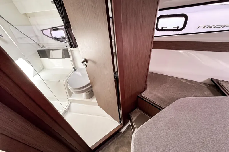 Slide: The Image of Interior of 2023 Beneteau Antares 11, featuring a compact bathroom and seating area. - 33