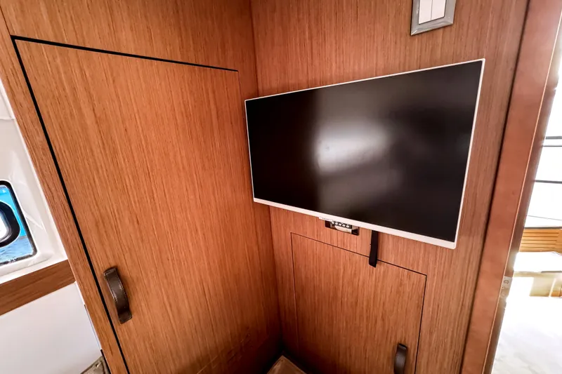 Slide: The Image of Interior of 2023 Beneteau Antares 11 with mounted flat-screen TV. - 36
