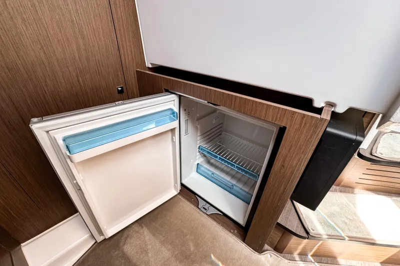 Slide: The Image of Open refrigerator inside 2023 Beneteau Antares 11 boat, showcasing modern interior design. - 38