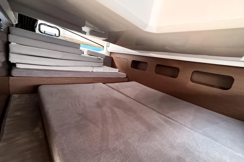 Slide: The Image of Interior cabin of 2023 Beneteau Antares 11 with cushioned seating and wooden accents. - 40