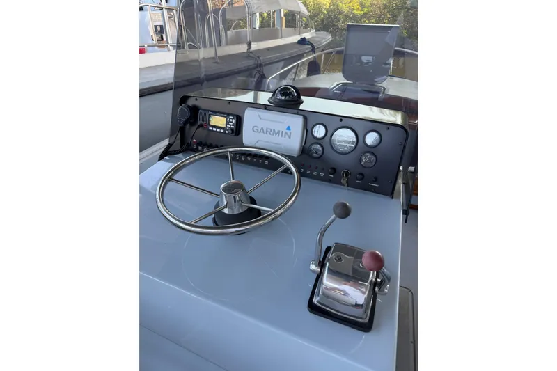 Slide: The Image of 2024 Strike 26 Center Console Cuddy helm with Garmin navigation system and controls. - 11