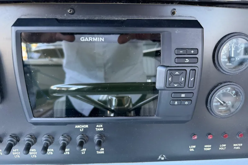 Slide: The Image of Control panel of a 2024 Strike 26 Center Console Cuddy with Garmin display and gauges. - 14