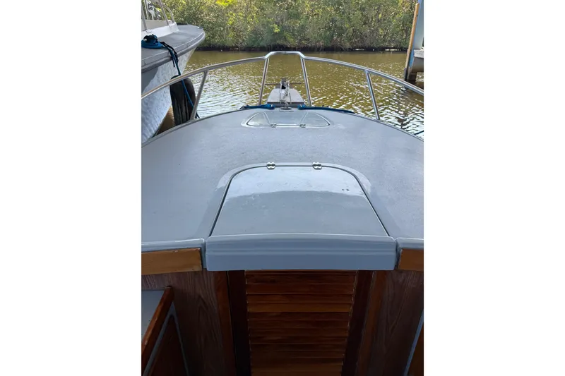 Slide: The Image of 2024 Strike 26 Center Console Cuddy boat docked, showcasing bow and railing. - 17