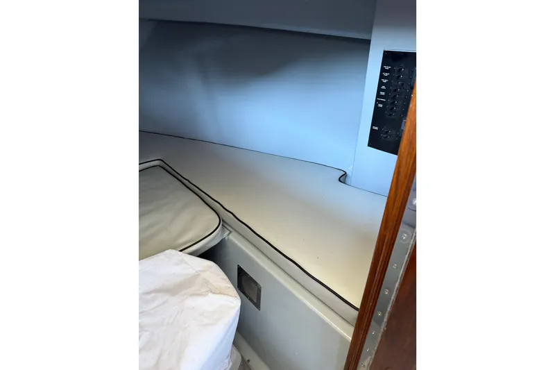 Slide: The Image of 2024 Strike 26 Center Console Cuddy interior with cushioned seating and control panel. - 18