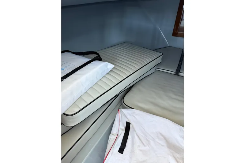 Slide: The Image of 2024 Strike 26 Center Console Cuddy interior with cushioned seating and storage. - 19