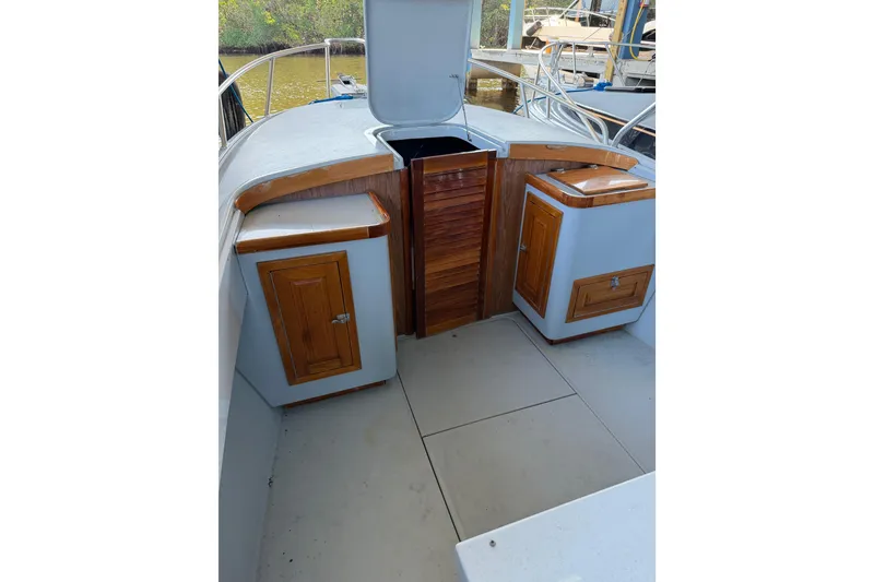 Slide: The Image of 2024 Strike 26 Center Console Cuddy interior with wooden cabinetry and open hatch. - 2
