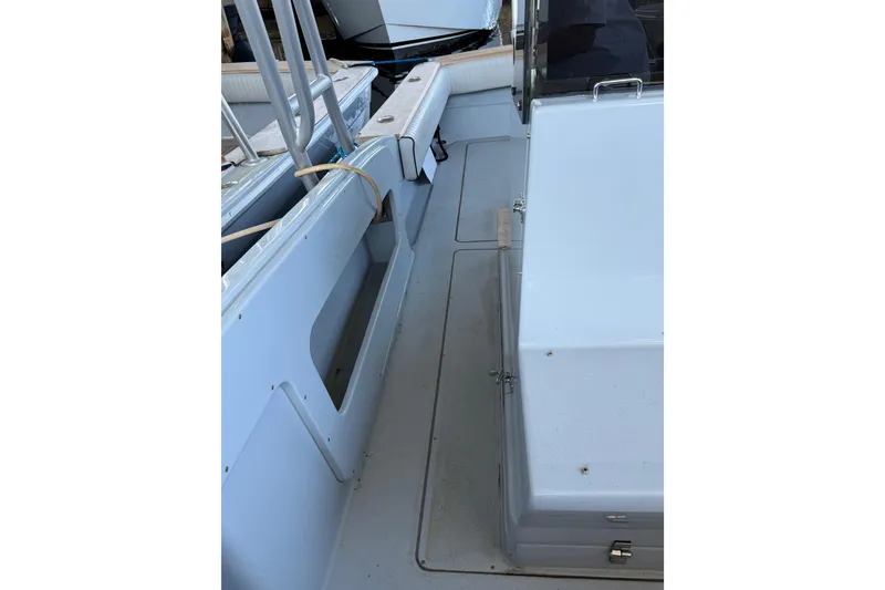 Slide: The Image of 2024 Strike 26 Center Console Cuddy boat interior, showcasing seating and storage areas. - 20