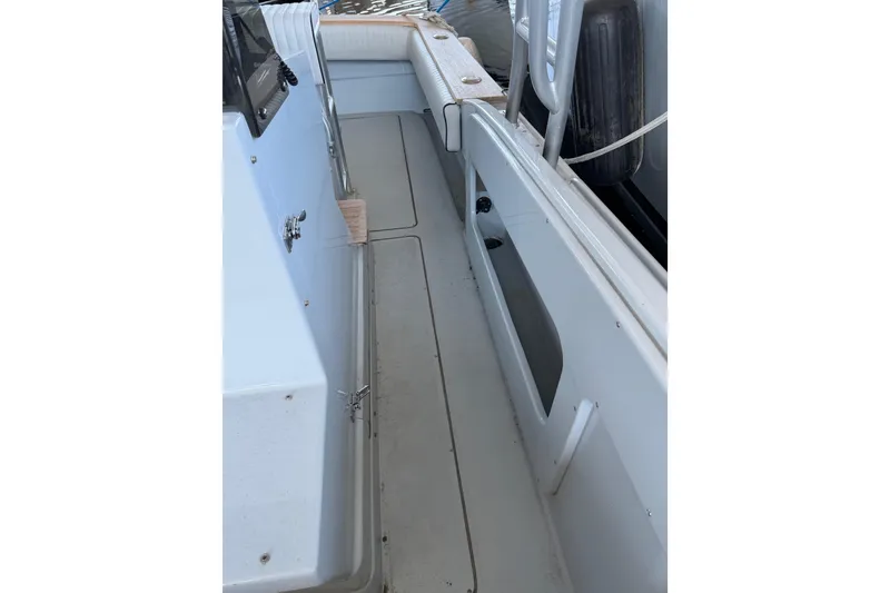 Slide: The Image of 2024 Strike 26 Center Console Cuddy boat interior with sleek white deck and seating. - 21