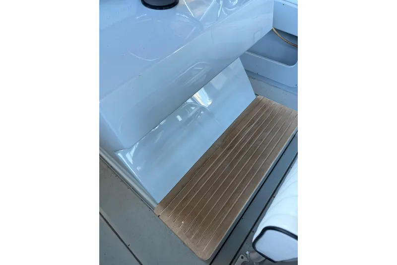 Slide: The Image of 2024 Strike 26 Center Console Cuddy boat interior with wooden flooring detail. - 23
