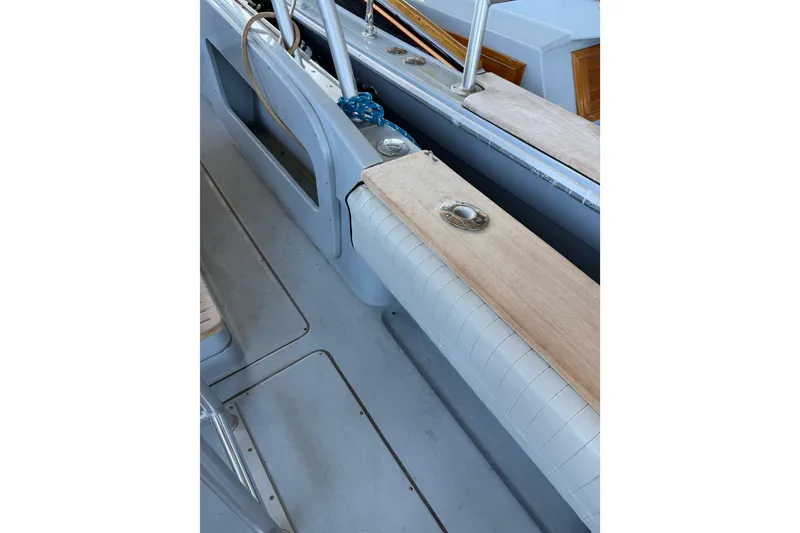 Slide: The Image of 2024 Strike 26 Center Console Cuddy interior with cushioned seating and wooden accents. - 25