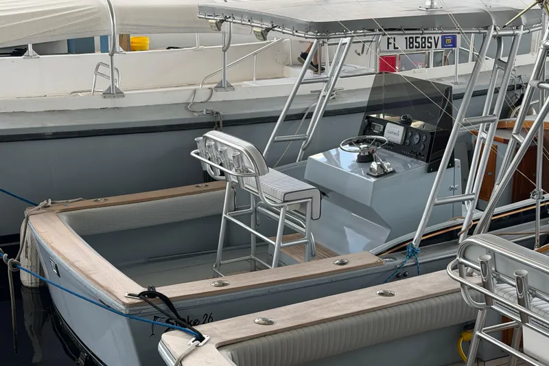 Slide: The Image of 2024 Strike 26 Center Console Cuddy boat docked, featuring sleek design and modern controls. - 28