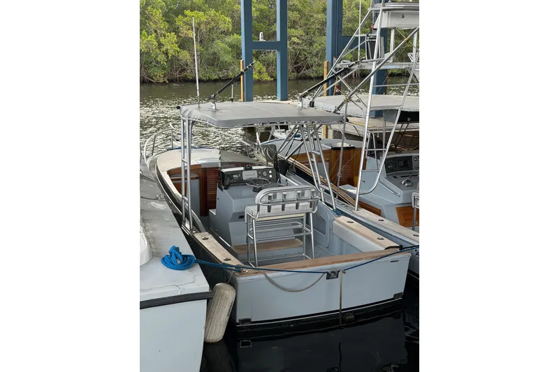 Slide: The Image of 2024 Strike 26 Center Console Cuddy boat docked, featuring sleek design and modern amenities. - 29