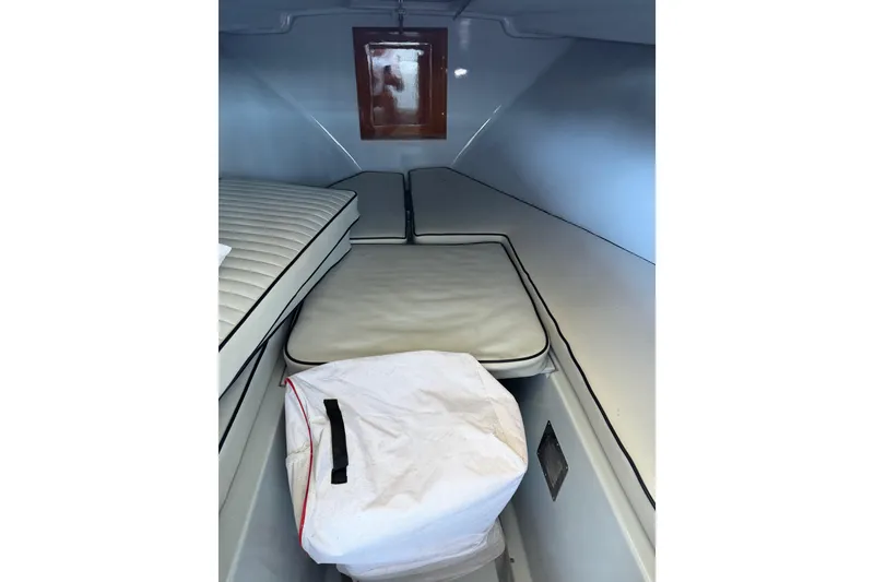 Slide: The Image of 2024 Strike 26 Center Console Cuddy interior with cushioned seating and storage. - 3