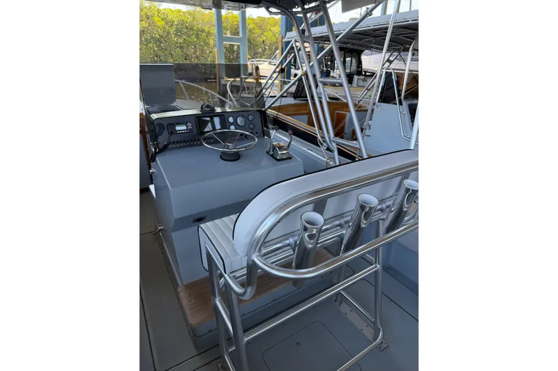 Slide: The Image of 2024 Strike 26 Center Console Cuddy boat interior with steering wheel and rod holders. - 7