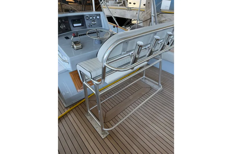 Slide: The Image of 2024 Strike 26 Center Console Cuddy helm with steering wheel and rod holders. - 9
