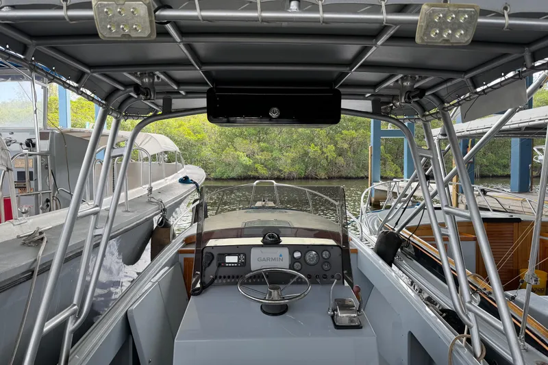 Slide: The Image of 2024 Strike 26 Center Console Cuddy boat interior with steering wheel and controls. - 1