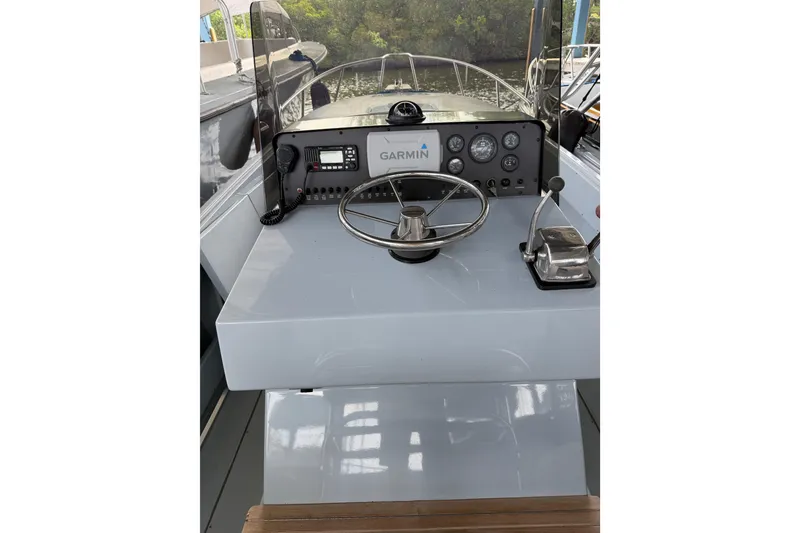 Slide: The Image of 2024 Strike 26 Center Console Cuddy helm with Garmin navigation system and controls. - 12