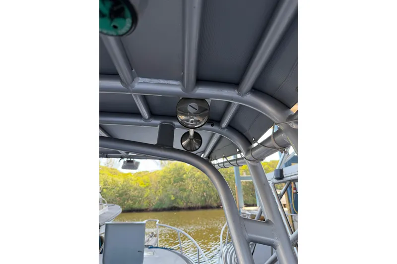 Slide: The Image of 2024 Strike 26 Center Console Cuddy boat interior with metal framework and river view. - 16
