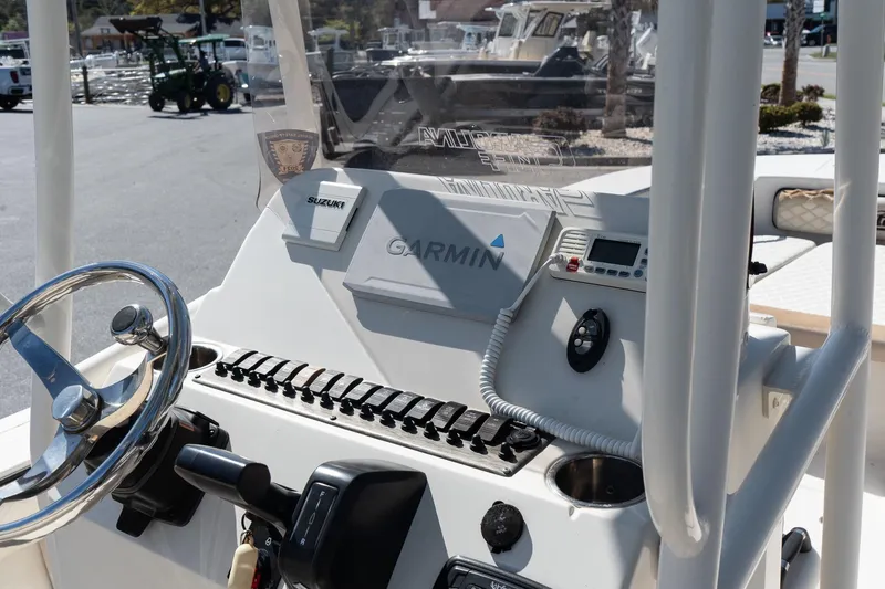 Slide: The Image of 2020 Carolina Skiff 24 Ultra Elite boat dashboard with Garmin and Suzuki controls. - 10