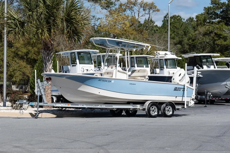 Slide: The Image of 2020 Carolina Skiff 24 Ultra Elite boat on trailer, parked outdoors. - 2