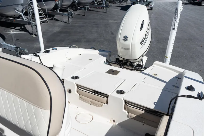 Slide: The Image of 2020 Carolina Skiff 24 Ultra Elite boat with Suzuki outboard motor in a parking lot. - 7