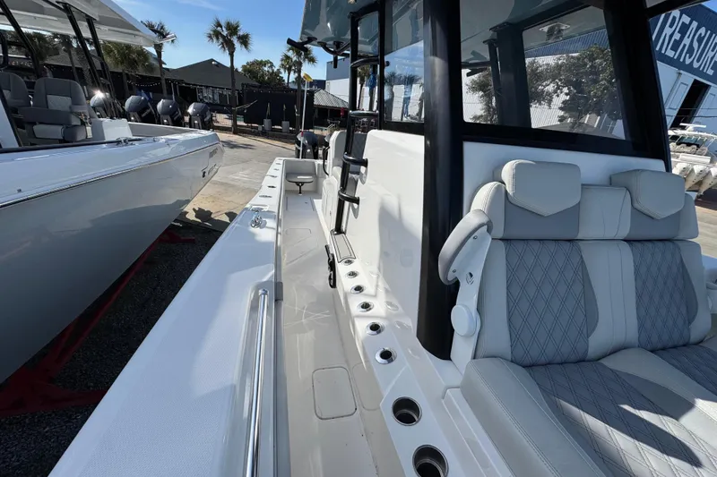Slide: The Image of 2021 Invincible 36 Open Fisherman boat interior with seating and rod holders. - 17